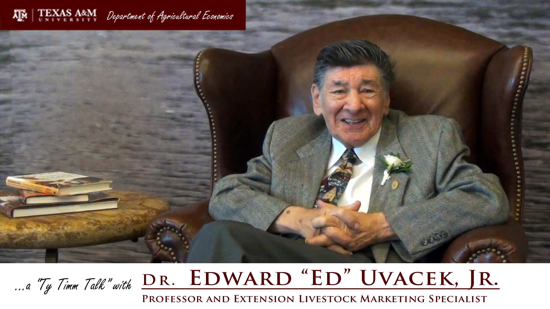 Thumbnail. The words "a ty timm talk with Dr. Edward "Ed" Uvacek, Jr. - Professor and Extension Livestock Marketing Specialist" run along the bottom. Dr. Uvacek is seated and wearing a grey suit, smiling. Click for interview