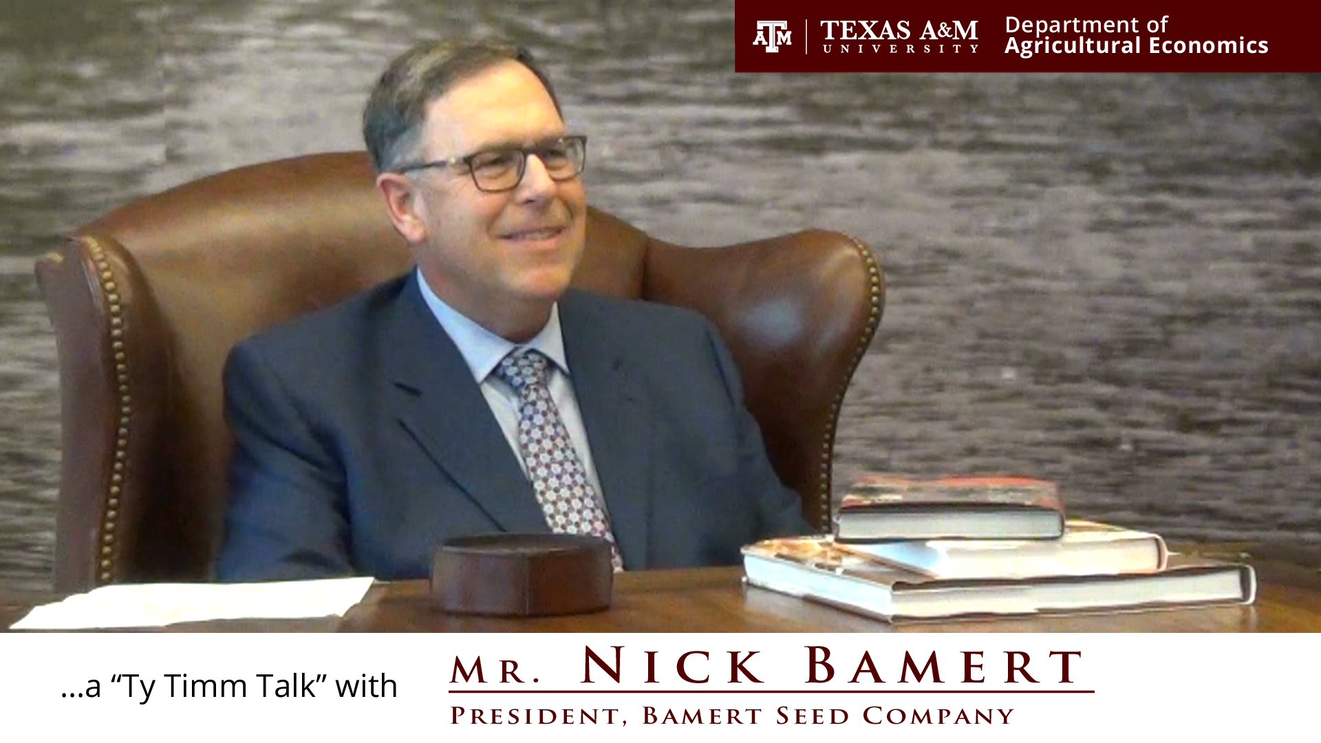 The words "A Ty Timm Talk with Mr. Nick Bamert, president bamert seed company" along the bottom. Nick Bamert, seated in brown leather chair, smiling and angled to the right, wears a blue suit with a dotted white and grey tie.