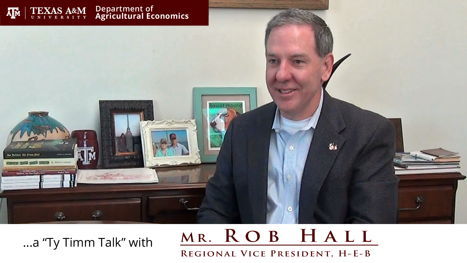 The words "a ty timm talk with Mr. Rob Hall - Regional Vice President, H-E-B" run along the bottom. Mr. Hall is seated and wearing a black suit, smiling.