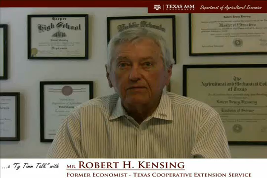 The words "a ty timm talk with Mr. Robert H. Kensing - Former Economist - Texas Cooperative Extension Service" run along the bottom. Mr. Kensing is seated in front of a wall of diplomas and wearing a blue and white button-up shirt.