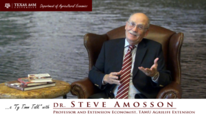 The words "A Ty Timm Talk with Dr. Steve Amosson, "Professor and Exstension economist, TAMU Agrilife Extension" run across the bottom. Dr. Amosson is seated in a brown leather chair, gesturing with his hands and smiling.