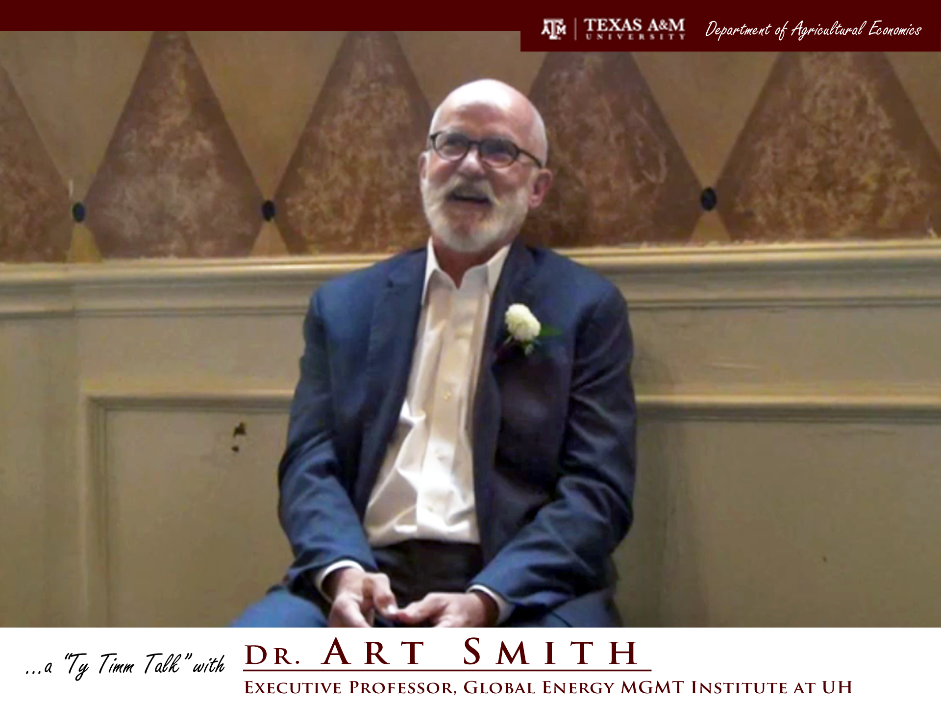 Thumbnail. The words "a ty timm talk with Dr. Art Smith - Executive Professor, Global Energy MGMT Institute at UH" run along the bottom. Dr. Smith is seated and wearing a blue suit, smiling. Click for interview