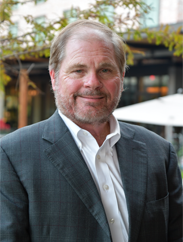 Roy Martin smiling in a grey suit